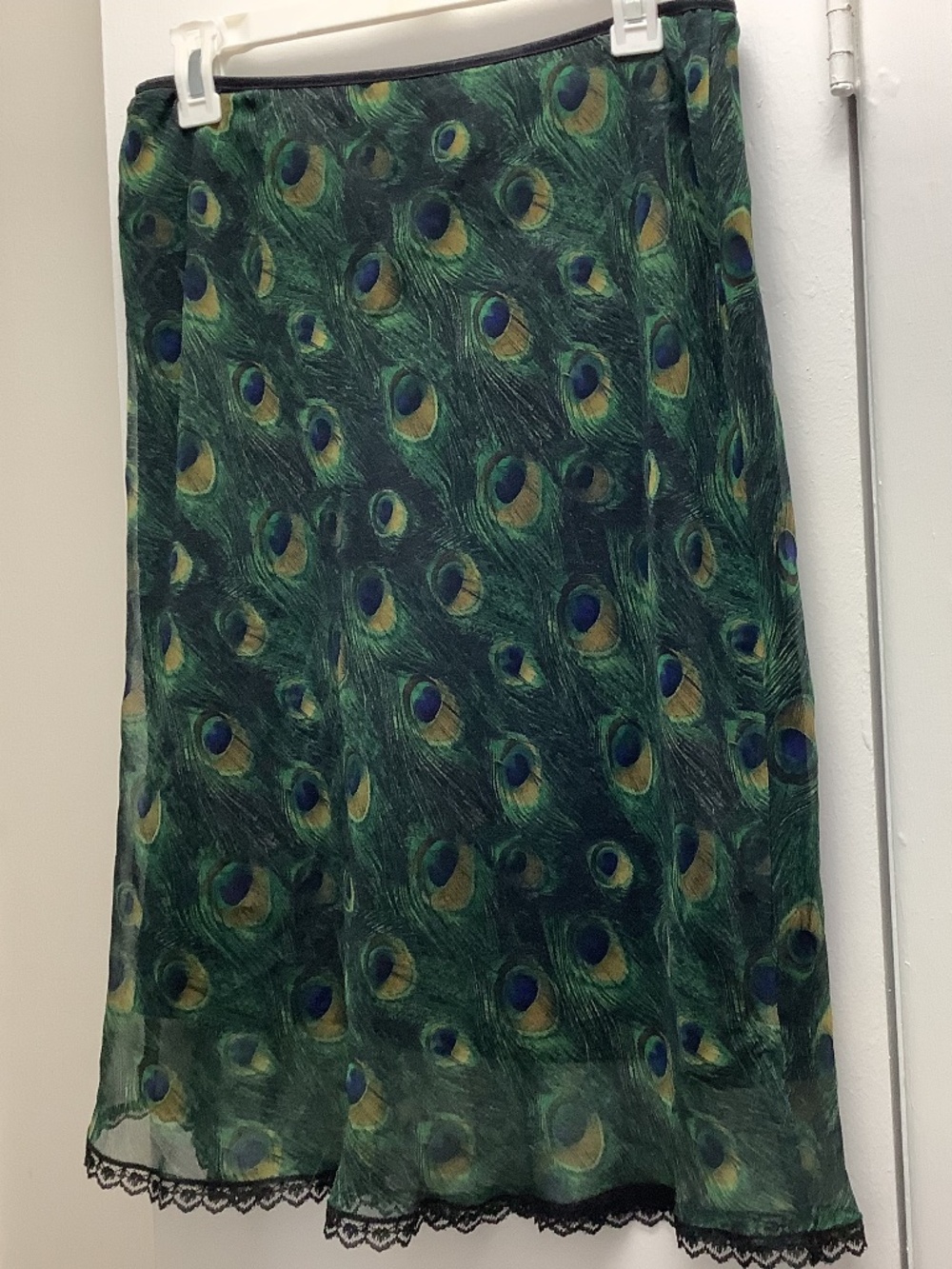 Peacock feather colors and pattern decorate this soft silky fabric skirt. Retro